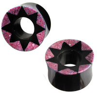 Cargar imagen en el visor de la galería, A pair of hand-carved black Horn Tunnel plugs with pink star patterns and textured details, offering a striking design for those who want the Ohrplug rosa Stern look.
