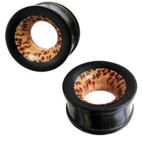 Load image into Gallery viewer, Two black Holztunnel ear plugs, hand-carved with circular centers. The inner side displays a brown and tan tribal dot pattern, contrasted by the smooth, dark exterior of Kokosholz and Eisenholz.
