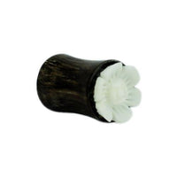 Cargar imagen en el visor de la galería, A dark brown hand-carved Tamarindenholz Holz Plug featuring a white bone Blume design, tribal style, is displayed on a plain white background.
