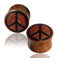Cargar imagen en el visor de la galería, Two Tribal Plug Peace Symbol schwarz rotbraun Rosenholz plugs, each cylindrical and made of rosewood with a black peace symbol on the face, are displayed on a white background with a subtle reflection.
