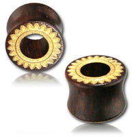 Load image into Gallery viewer, Two dark brown Holz Tunnel Tamarind Wood Tribal Plugs, organic and hand-carved with a gold-painted Sonnenblume laser engraving on the flared front, are displayed against a white background.
