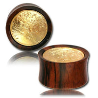 Load image into Gallery viewer, Two Holz Plug two tone Arang Wood Brass Inlay tunnels, featuring flared edges and an antique golden tribal design, are shown on a white background—one lying flat and the other upright to display both polished surfaces.
