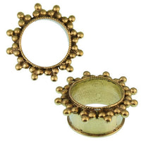Cargar imagen en el visor de la galería, Two antik gold, nickelfree Brass Tunnel Seil Sonne plugs with raised bead edges are shown on a white background—one standing, one flat—displaying the organic Messing Expander Ohrschmuck design from side and top views.
