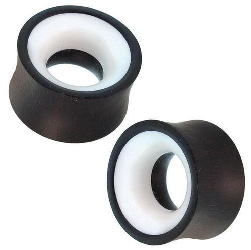 Two hand-carved Holz Tunnel Bone Inlay weiß schwarz Eisenholz Tribal Plugs with a concave, double-flared design and bone inlay accents are displayed on a white background.
