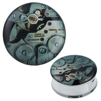 Cargar imagen en el visor de la galería, A round Plug Tunnel Uhrwerk in green stainless steel and acrylic with a top lid featuring Metalluhrwerk Zahnräder and gears, shown from above and at an angle.
