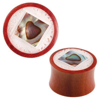 Cargar imagen en el visor de la galería, The Organic Sabaholz Plug Paua Abalone eckig gerahmt Perlmutt Tunnel Tribal Expander features a round wooden design with a square Paua Abalone inlay, heart center, and intricate white carved detailing on the slightly flared edge.
