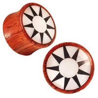Load image into Gallery viewer, A pair of Rangas Holz Plug in dark brown wood, each with a white shell inlay and a black star design radiating from the center.
