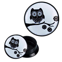 Load image into Gallery viewer, Round black Schraub Plug Acryl with a lid featuring a black-and-white owl on a branch design. The lid can be closed or removed to reveal the Expander Piercing Ohrschmuck inside.
