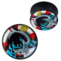 Cargar imagen en el visor de la galería, A pair of round black Plug Acryl Hai Wellen Rettungsring Seil Piercing Ohrschmuck with glänzender Vorderseite, featuring a stylized skull with blue flames and red, white, and yellow face accents.
