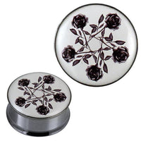 Load image into Gallery viewer, The Tunnel silbern Edelstahl Plug features a white acrylic top with six black roses arranged in a circular, pentagram-style design—reminiscent of a classic Rosen Edelstahl Tunnel.
