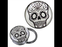 Load image into Gallery viewer, A silvery stainless steel screw plug tunnel piercing with a black and white Candy Skull acrylic design, featuring floral eye patterns and a spiderweb on the forehead, inspired by Skull Motiv art.
