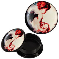 Load image into Gallery viewer, The Schraub Plug Acryl Engelchen sitzend rot weiß schwarz Piercing Ohrschmuck features a black base with a vivid, painterly image of a red-haired, seated angel, making this unique Ohr Plug a standout piece.
