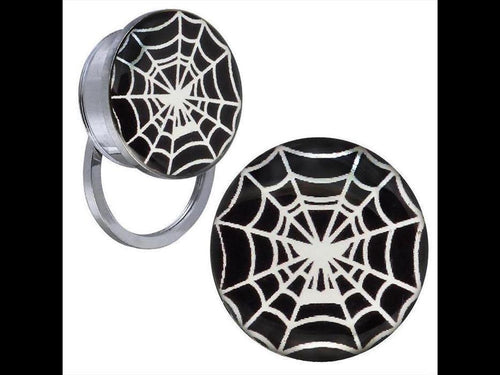 A pair of Schraub Plug Tunnel earrings made of silver stainless steel with black and white spiderweb acrylic tops, shown on a plain background.