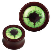 Load image into Gallery viewer, Two round, reddish-brown Holz Plugs named &quot;Holz Plug rotbraun Auge hellgrün schwarz Acryl Inlay Tribal Piercing,&quot; each featuring a light green eye design with a black acrylic inlay in the center.
