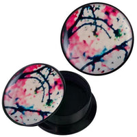 Load image into Gallery viewer, A round black Acryl Schraub Plug, &quot;Schraub Plug Acryl Kirschblüten groß rosa weiß schwarz Piercing Ohrschmuck,&quot; with a removable lid and abstract pink, blue, and green ink-art design, is shown partially open with an empty interior.
