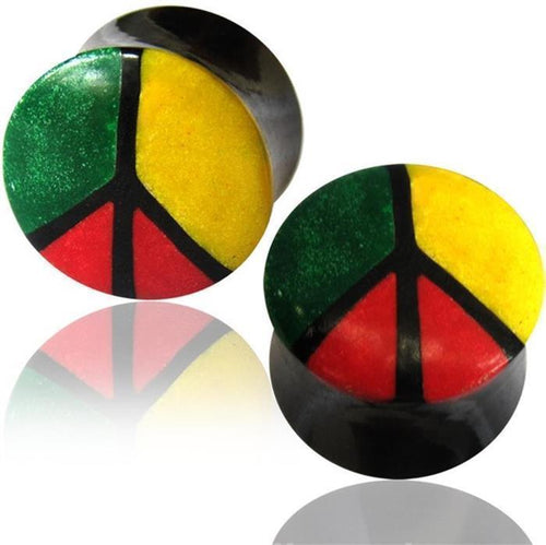 A pair of black round horn plugs, named "Horn Plug Bone Inlay Rasta Peace rot gelb grün," features a bone inlay peace sign with green (top left), yellow (top right), and red (bottom) sections, separated by bold black outlines.