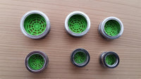 Load image into Gallery viewer, Six cylindrical plugs, including the Schraubplug Chirurgenstahl Tunnel Edelstahl silber Spinnennetz Neon Grün Acryl Plug, feature neon green spiderweb-patterned mesh. Arranged in two rows on wood, their sizes descend from top to bottom.
