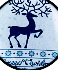 Load image into Gallery viewer, A blue reindeer silhouette with antlers stands on a snowy, patterned background, echoing the festive design of the Schraub Plug Acryl Rentier Weihnachten blau weiß Schneeflocken Ohrschmuck for your next lobe piercing.
