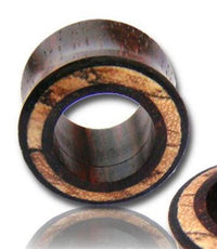 Load image into Gallery viewer, A close-up of a round Holz Flesh Tunnel Inlay Tamarinden Holz braun hell Plug, made from handgeschnitzt wood, displays a dark center with a textured, light brown ring and an organic, natural wood-grain appearance for stretched ears.
