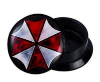 Load image into Gallery viewer, A round black Schraub Plug Acryl Schirm Kreuz rot weiß Expander Piercing Ohrschmuck with a partially open lid, displaying a red and white umbrella-shaped geometric design on top.
