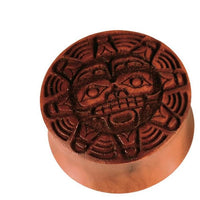 Load image into Gallery viewer, A round, brown wooden stamp with a carved Aztec-style sun face, bold lines, and geometric patterns, similar to the Sawo Holz Plug Gravur handgeschnitzt Gesicht Sonne, shown against a plain white background.

