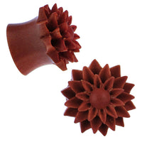 Load image into Gallery viewer, Two reddish-brown hand-carved Holzplug Sawoholz Dalie ear plugs, featuring a floral design with pointed petals and round centers, are shown from various angles against a white background.
