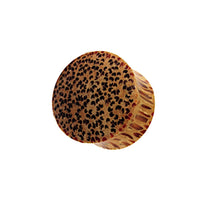 Cargar imagen en el visor de la galería, The &quot;hell Holz Plug Punkte Muster Kokosholz handmade&quot; is a round, brown Kokosholz plug featuring black oval spots and a textured, ridged side, shown on a white background.
