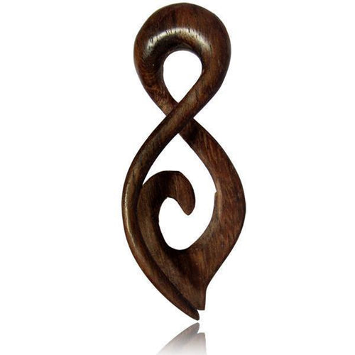A Piercing Narra Holz Twister in brown with a loop, pointed tip, and spiral expander design, featuring a unique grained finish—ideal as a standout plug or addition to your piercing collection. Shown photographed on white.