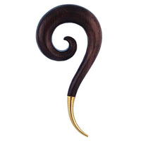 Cargar imagen en el visor de la galería, A decorative piece inspired by the graceful curves of the Piercing Holz Sonoholz Spirale Brass Spitze Plug Ohrstecker Expander, crafted from dark polished wood with a golden pointed tip, resembling a question mark.
