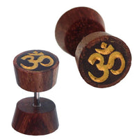 Cargar imagen en el visor de la galería, Fake Holz Plug Tamarinde dunkelbraun schwarz Maserungen OM-Zeichen golden Piercing

