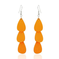 Cargar imagen en el visor de la galería, A pair of &quot;Holzohrringe Tropfen lang 68 mm Tribal Ohrringe&quot; featuring three stacked, teardrop-shaped orange pieces, crafted from colorful wood and stainless steel, nickel-free, hanging from silver hooks against a white background.
