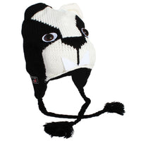 Load image into Gallery viewer, The Unisex Tiergesicht Mütze Norwegermütze Nepalmütze Strick Tiermützen Bommeln is a black and white knit hat with a tier face, two eyes, black ear flaps with braided tassels, and two pointed white felt teeth.
