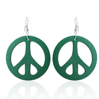 Cargar imagen en el visor de la galería, A pair of round 50 mm green Holzohrringe with cut-out Peace signs and nickel-free stainless steel hooks. The Ohrringe, &quot;Holzohrrringe Holz rund Peace,&quot; are shown on a white background with a subtle reflection.

