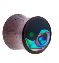 Cargar imagen en el visor de la galería, The Sonoholz Plug Yin Yang Inlay features vibrant paua abalone resin in a black tunnel expander, offering a tribal-inspired wooden ear plug with an eye-catching yin-yang design.

