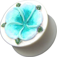 Load image into Gallery viewer, A Tribal Plug Bone in white, hand-carved, with a blue and green flower inlay—an Organic Expander Tunnel Piercing.
