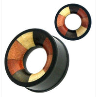 Load image into Gallery viewer, The &quot;vierfarbig Holztunnel handgeschnitzt verschiedene Holzarten Tribal Tunnel Plug Expander&quot; features a circular shape with a bold black rim and segments of brown, gold, and reddish-orange forming a striking geometric pattern.
