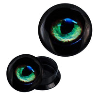 Load image into Gallery viewer, A pair of black Schraub Plug Acryl ear plugs featuring a realistic green and blue puma eye design, with one plug’s cap removed to display its hollow interior.
