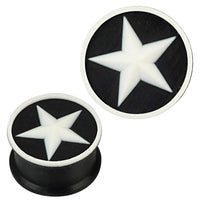 Load image into Gallery viewer, Two round Silikon Plug weich schwarz weiß with a raised edge, each featuring a white star design in the center. These stylish Piercing Ohrschmuck plugs are ideal as body jewelry or ear gauges.
