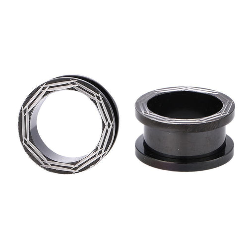 Two Chirurgenstahl Schraubplugs in black with silver line designs, one upright and one on its side, are displayed against a white background.