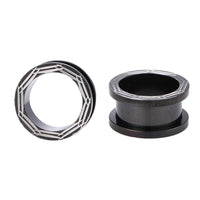 Cargar imagen en el visor de la galería, Two Chirurgenstahl Schraubplugs in black with silver line designs, one upright and one on its side, are displayed against a white background.
