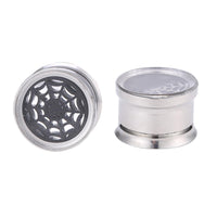 Load image into Gallery viewer, A pair of Chirurgenstahl Plug silber Farben, one displaying a black Spinnennetz motiv under glass, the other shown from the side—both are thin, screw-fit plugs crafted from shiny surgical steel.
