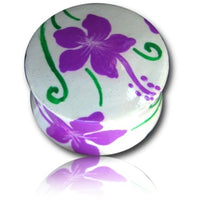 Load image into Gallery viewer, A round, white Holz Plug Hawaii Blume lila grün Tunnel Ohrschmuck with hand-painted purple flowers and green vines on lid and side, inspired by Hawaii, shown against a white background with a faint reflection below.
