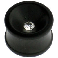 Cargar imagen en el visor de la galería, A hand-carved black Eisenholz plug with a concave shape and a clear Kristall at its center, inspired by Tribal Holzplug designs, is shown against a white background.
