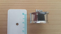 Load image into Gallery viewer, An Edelstahl Tunnel Plug Flügel Herz Stein facettiert Schraubplug double flared, ring-shaped and metallic, lies next to a centimeter ruler on a light wooden surface, appearing to be about 2 centimeters wide.
