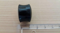 Cargar imagen en el visor de la galería, A hand-carved Buffalo Horn Plug Perlmutt Inlay weiß Lobe Piercing Tunnel with slightly concave sides lies on a wooden surface next to a transparent centimeter ruler.
