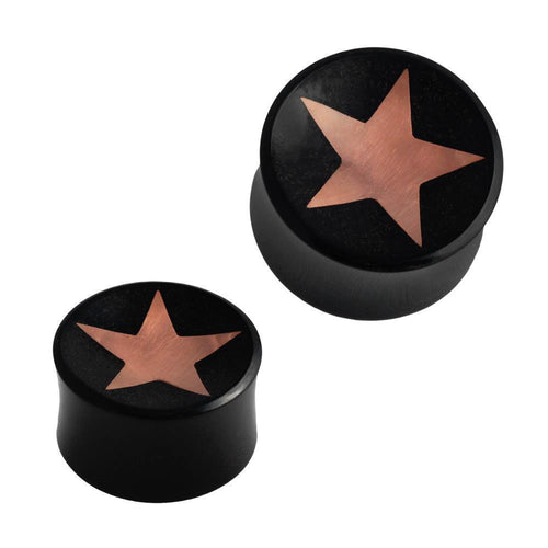 Two black, cylindrical Horn Plug Stern Inlay metallic rosegold schwarz Expanders, handcrafted with flat tops and a metallic rose gold star center. Both flesh tunnels are shown on a white background, one slightly larger than the other.