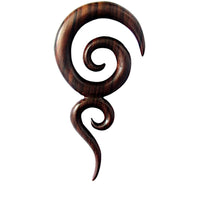 Cargar imagen en el visor de la galería, The Sonoholz lang Tribal Piercing Holz zwei Spiralen handmade is a dark wooden earring with smooth, curving spirals and pointed ends, making it a striking accessory set against a white background.
