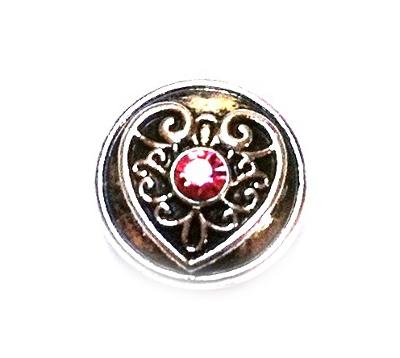 A round, metallic Click-Button from Chunks Buttons Druckknöpfe, featuring a pink heart ornament—ideal for adding elegance to your Edelstahl Lederarmband.