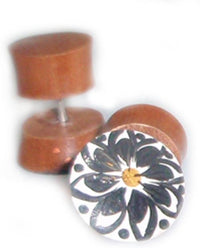 Load image into Gallery viewer, A pair of Tribal Fake Plug Holz Edelstahl Tunnel Sonoholz earrings, one shown upright with a hand-painted black and white floral design and yellow center, the other lying on its side revealing the metal post.
