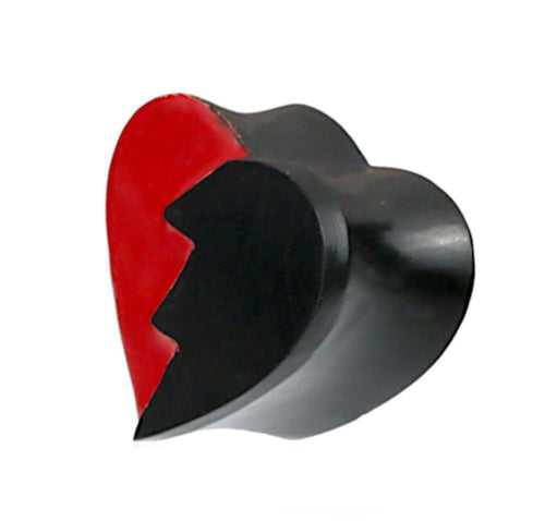 A heart-shaped Plug Herz gebrochen schwarz rot Holz broken Heart features one jagged half in red, the other in black, set against a white background, echoing a unique split-heart wooden plug design.